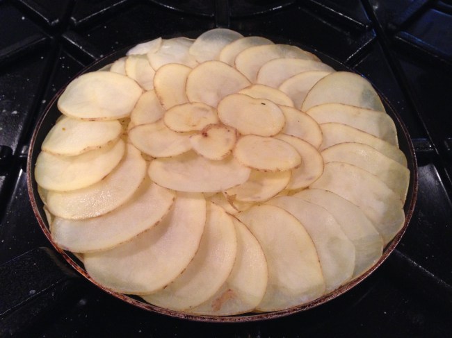 Yukon Golds sliced thin on a mandelin and layered with salt and pepper and a little melted butter